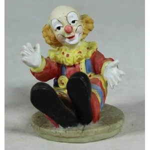 Miniature seated clown with arms stretched open